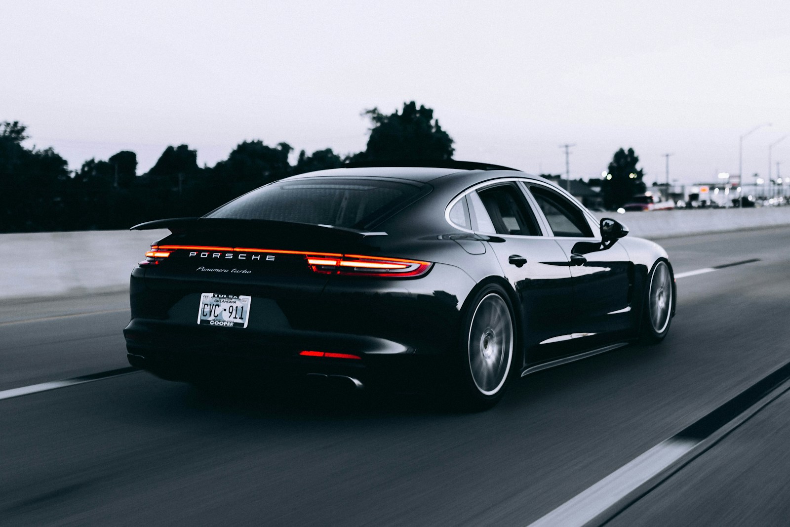 running black Porsche sedan with auto insurance